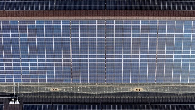 Aerial view of solar panels installed on a large industrial rooftop in Denver, Colorado, United States.