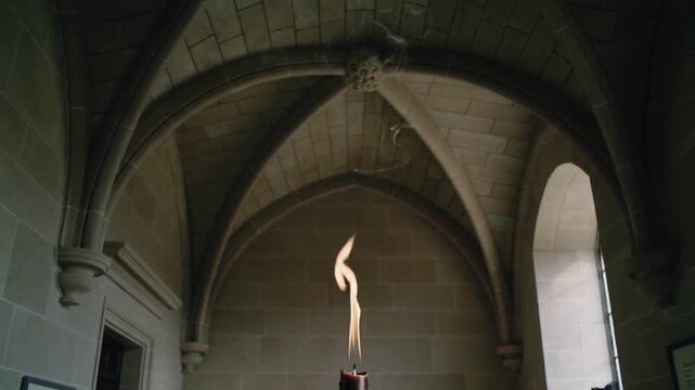 Glowing ember sparking central charred candle sending twisting flame and curling smoke in chapel