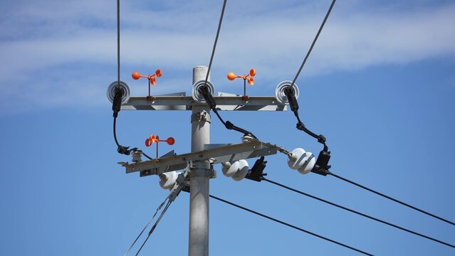 Electric power pole insulators against blue sky