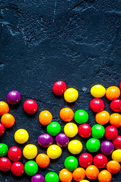 sweets and sugar candies on dark background top view