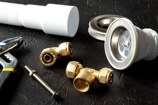 concept plumbing tools on dark background