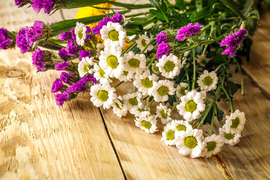 bouquet spring flowers on wooden board