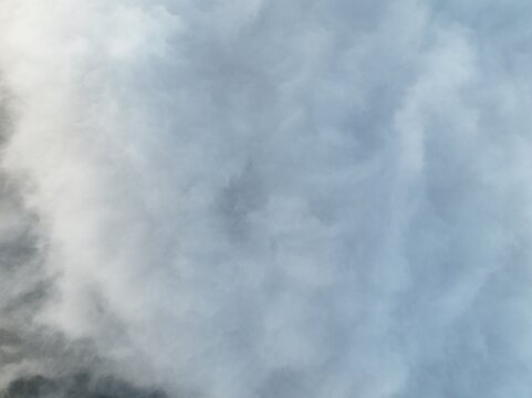 Aerial view of Triangle Sky Telomoyo shrouded in dense clouds and thick fog over the mountainous landscape in Kecamatan Ngablak, Jawa Tengah, Indonesia.