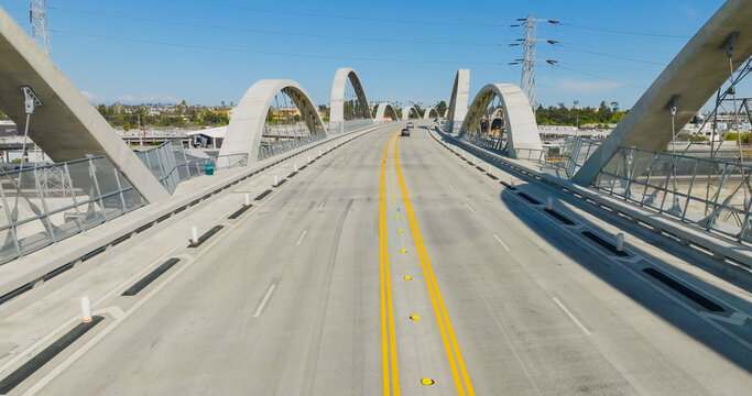 Aerial view of the 6th Street Viaduct featuring its iconic concrete arches and multi-lane roadway in Los Angeles, California, United States.