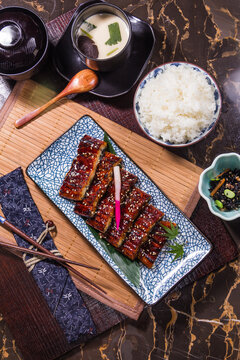 Delicious meal served on a table with rice, soup, and grilled eel