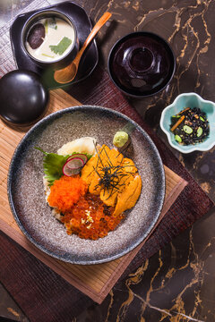 Japanese seafood dish served on a table with side dishes and soup