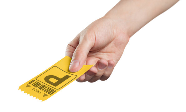 Hand holding yellow parking ticket for car access and payment, isolated on transparent cutout background