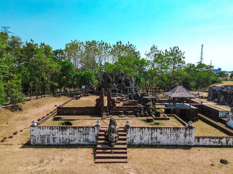 Aerial view of Sunyaragi Cave Park featuring its unique rock formations, historic stone structures, and surrounding lush trees in Cirebon, West Java, Indonesia.