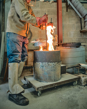 A Molten pot scorching molten hot lava refining furnace, precious metal smelting and industrial metallurgy. Precious metals being smelted and melted fashioned into artefacts.