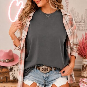 Cowgirl model in casual summer outfit. Western, southern woman in dark gray shirt with open plaid shirt over it, light blue frayed denim shorts. Howdy, country woman indoor mockup