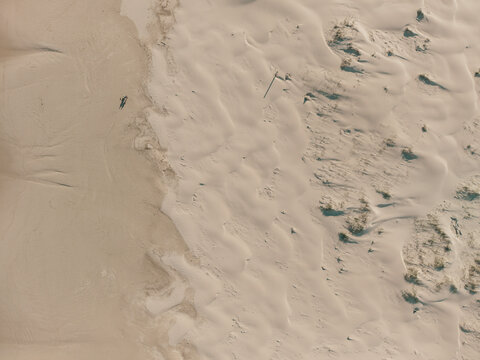 Aerial view of Birubi Point sand dunes with rippled textures and sparse vegetation in Anna Bay, New South Wales, Australia.