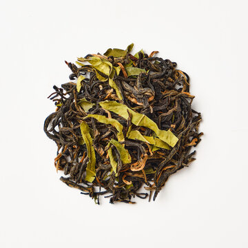 Dried herbal tea blend with yellow leaves on white background