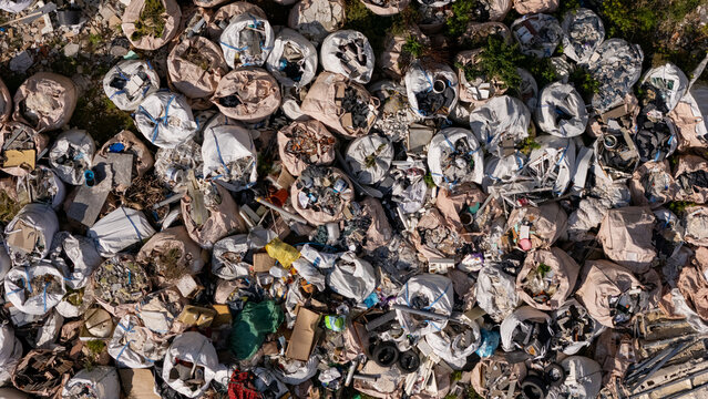 Aerial view of a large collection of industrial waste and construction debris stored in numerous white polypropylene bulk bags in a yard in Gdansk, Poland.
