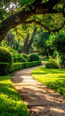 Obraz premium A sun-dappled garden path winds through lush greenery and manicured bushes.