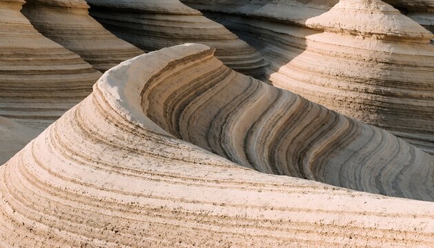 Layered sandstone rock formations, abstract geological patterns in desert canyon, natural stone texture background