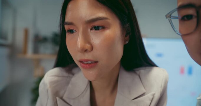 Young Asian business colleagues discussing project on computer at office. Corporate teamwork meeting, marketing report analysis, strategy planning development, professional manager advice concept.