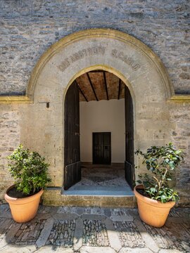 Charming Mediterranean travel photo featuring the historic Orfanotrofio San Carlo entrance in Erice, ideal for Sicilian culinary heritage, history, and travel media.