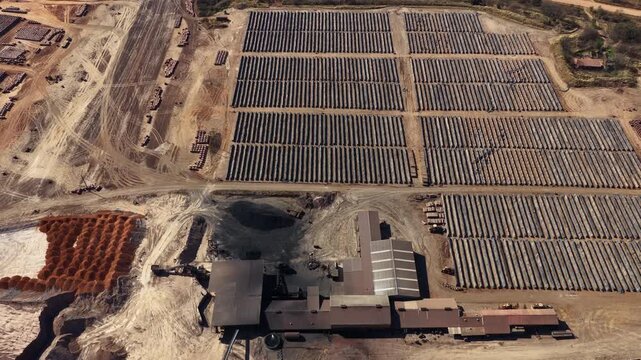 Coal-powered clay brick plant with long drying rows and raw material stockpiles
