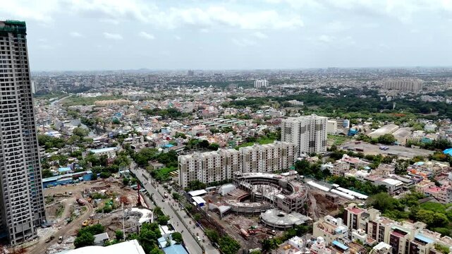 Cinematic aerial view of Perambur, Chennai, showcasing high-rise residential towers, large apartment complexes, an ongoing construction project, busy local roads, and a densely populated urban lands
