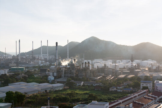 Aerial view of oil refinery plant in Laem Chabang Industrial Estate, Chonburi, Thailand, featuring processing units, storage facilities, smokestacks, pipelines, petrochemical infrastructure.