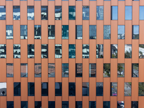 Aerial view of the modern copper-colored facade of a building in Gdansk, Poland.