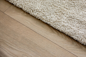 Soft Beige Carpet Edge on a Natural Wooden Floor