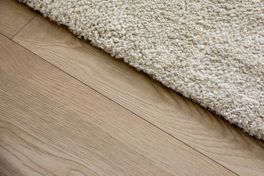 Soft Beige Carpet Edge on a Natural Wooden Floor