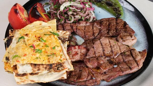 Turkish Kebab Dish with grilled meat, pita bread, and vegetables presented on a white background
