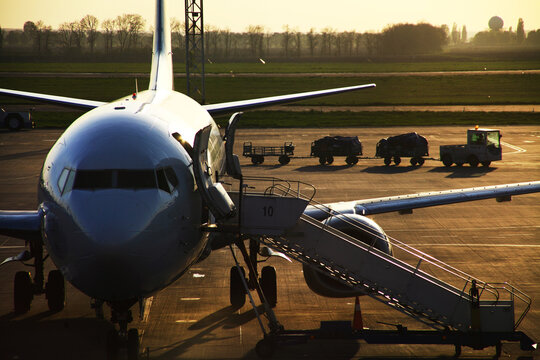 Airplane on runway at Boryspil International Airport near Kyiv, Ukraine during golden sunset. g.
