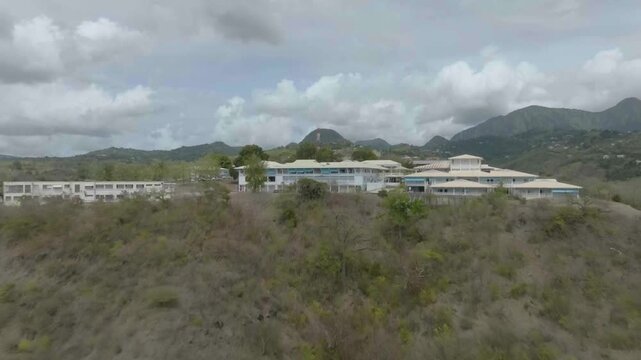 drone going back from hospital nord caraibe towars the edge of the plague du coin in martinique, france n volcano pelle in the background