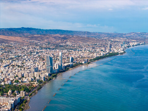 Aerial view of Limassol Marina and the coastal skyline of Lemesos, featuring modern high-rise buildings, urban density, and the Mediterranean Sea in Lemesos, Lemesos, Cyprus.