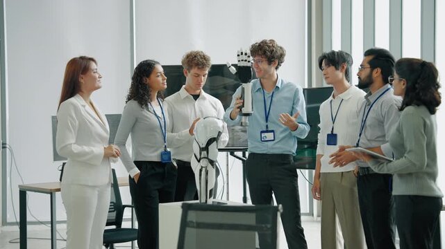 A diverse engineering team collaborating around a humanoid robot prototype while discussing robotics, artificial intelligence, automation, and future technology.
