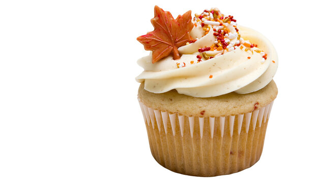 Vanilla cupcake with cream frosting and a decorative maple leaf sugar topper