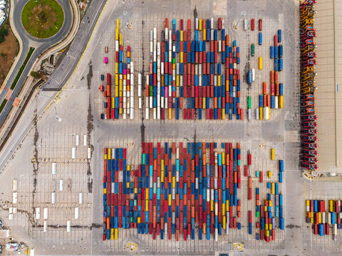 Aerial view of the busy container terminal at Limassol Port featuring rows of colorful shipping containers arranged on the asphalt yard in Lemesos, Lemesos, Cyprus.