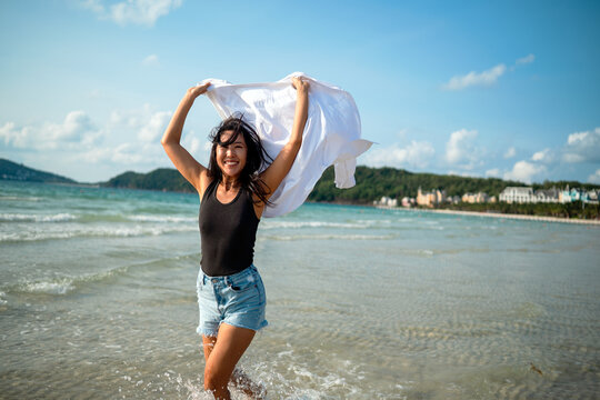 Mindful woman connecting with nature and feeling the breeze during a peaceful morning on the beach