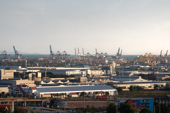 Aerial view of Laem Chabang Industrial Estate and Port, Chonburi, Thailand, featuring container cranes, warehouses, factories, logistics infrastructure, shipping terminal, transportation hub.