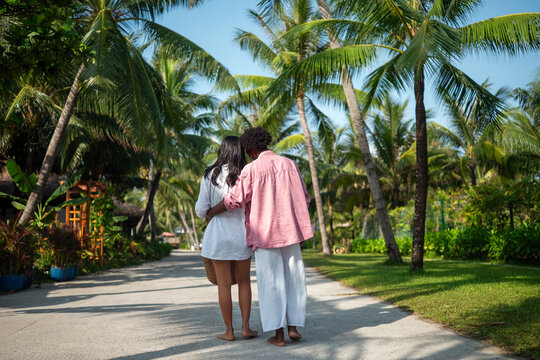 Happy interracial couple embracing and sharing a romantic moment during a tropical island getaway