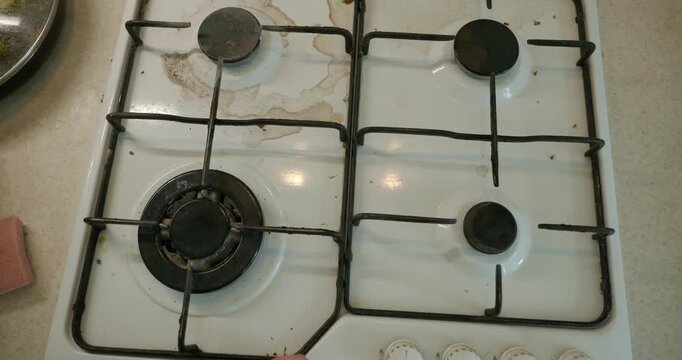 Close-up children's hands wash gas stove kitchen. 4K 10-bit