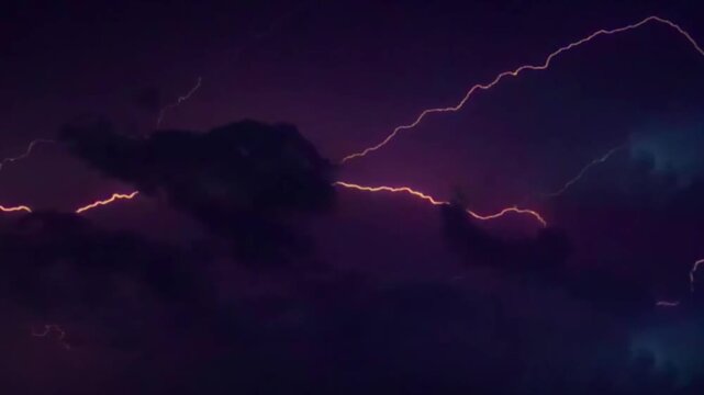 Dramatic lightning strikes and flashing thunderbolts in a dark stormy night sky