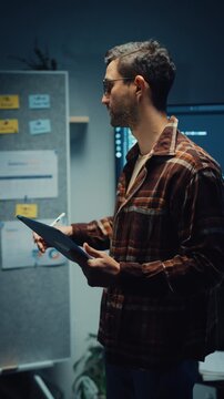 Vertical Screen : Caucasian male engineer presents software strategy during late night work in office. Experienced tech consultant expertise, Innovative startup leader, Professional online conference.
