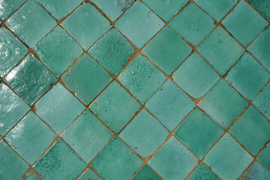 Diagonal pattern of traditional Moroccan green zellige tiles texture