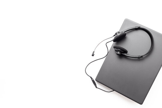Customer support workspace with laptop and headset - remote call center service concept, top view office flat lay