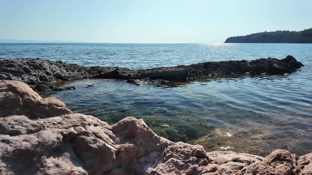 Rocky coastline and crystal clear waters on the Aegean Sea on the island of Thasos, Greece