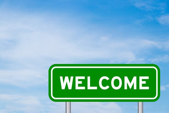 Green color transportation sign with word welcome on blue sky with white cloud background