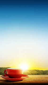 A red coffee cup on a wooden table with a stunning sunrise background, perfect for morning concepts. Good Morning Concept