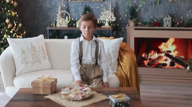 Happy child on Christmas, enjoying some quality time, opening presents, kids on Christmas eve in decorated home