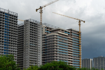 High rise buildings under construction with cranes © IbragimovN