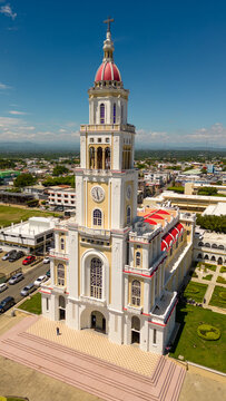 Aerial view of the Sagrado Corazon de Jesus Church with its prominent bell tower and red dome, surrounded by the town of Moca, Espaillat Province, Dominican Republic.