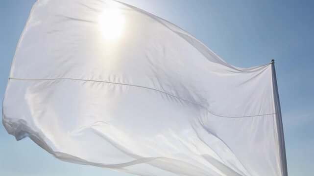 Billowing thin fabric fixed top-right unfolding against blue sky as wind gusts lifting