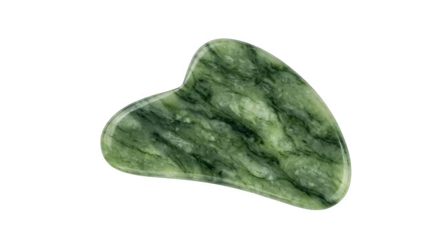 Green jade gua sha tool for facial massage isolated on white background